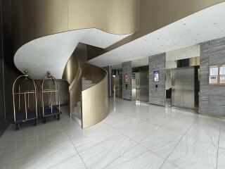 Lobby with spiral staircase and elevators