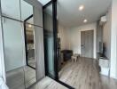 Modern living room with wooden flooring and large mirrors