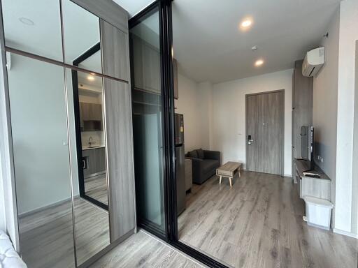 Modern living room with wooden flooring and large mirrors