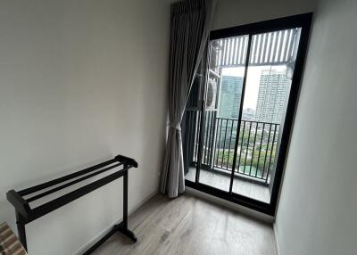 Small bedroom with window and balcony view