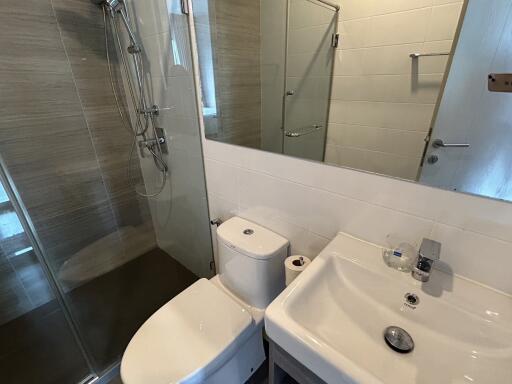 Modern bathroom with shower, toilet, and sink