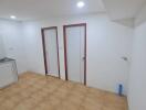 Spacious kitchen with tiled flooring and ceiling lights