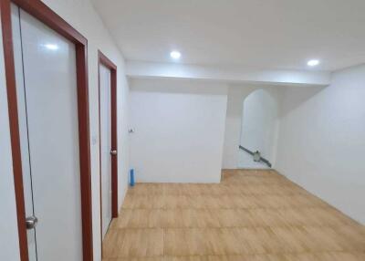Spacious hallway with tiled flooring and recessed lighting