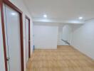 Spacious hallway with tiled flooring and recessed lighting