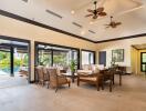 Modern living area with pool views and ceiling fans