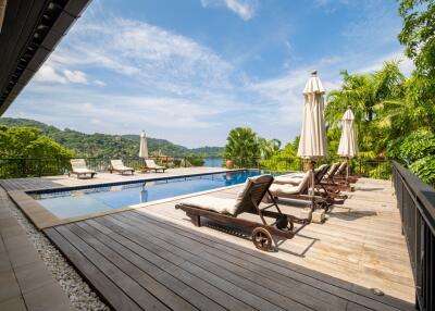 luxurious outdoor pool area with lounge chairs and scenic view