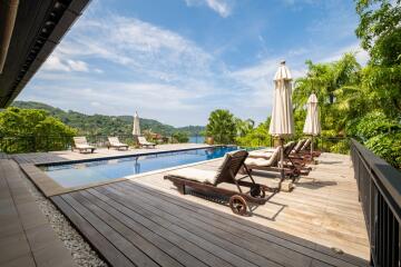 luxurious outdoor pool area with lounge chairs and scenic view