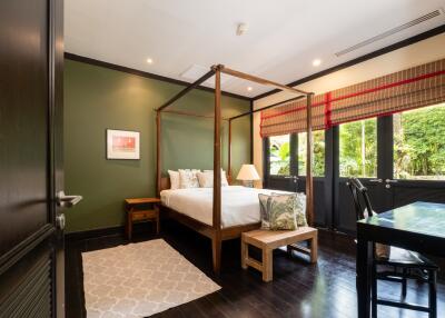 Spacious bedroom with canopy bed and garden view