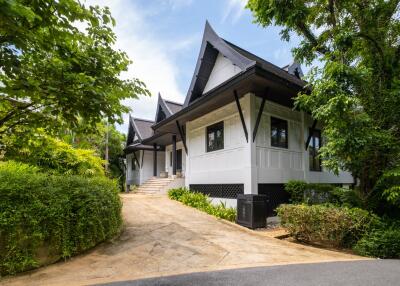 Beautiful house with unique architecture surrounded by greenery