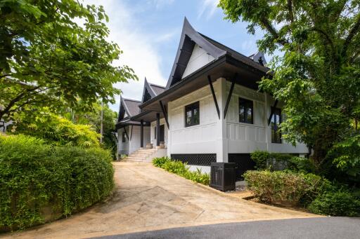 Beautiful house with unique architecture surrounded by greenery