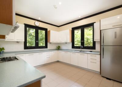 Modern kitchen with large windows and stainless steel appliances