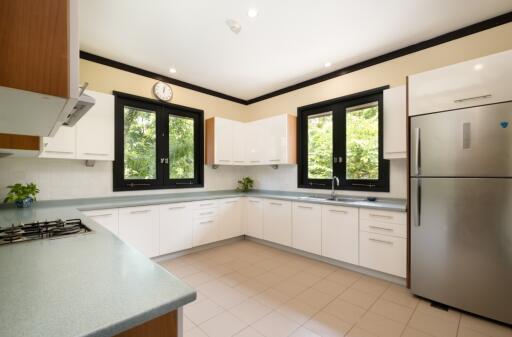 Modern kitchen with large windows and stainless steel appliances