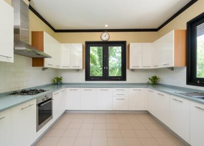 Modern kitchen with white cabinets and stainless steel appliances