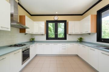 Modern kitchen with white cabinets and stainless steel appliances