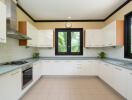 Modern kitchen with white cabinets and stainless steel appliances