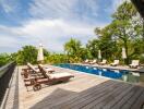 Luxurious outdoor pool area with lounge chairs and umbrellas