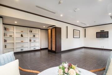 Spacious modern living room with built-in shelves and wall-mounted TV