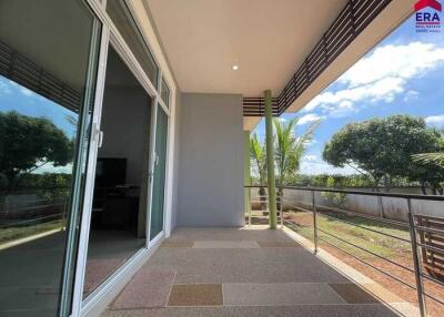 spacious balcony with a view of trees and a partially covered ceiling