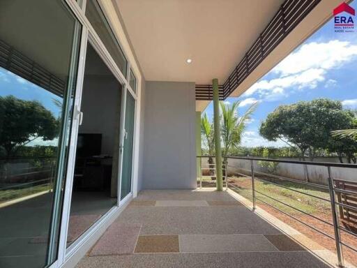 spacious balcony with a view of trees and a partially covered ceiling