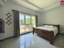 Bedroom with large window and wooden bed