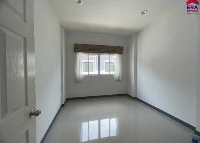 Empty room with a window and tiled flooring