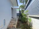 Side entrance with outdoor greenery