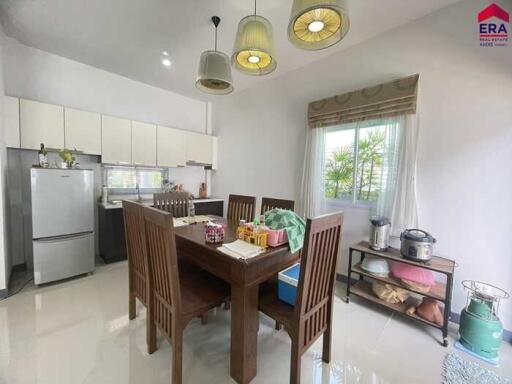 Modern kitchen and dining area with table and chairs