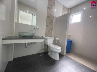 modern bathroom with glass sink and walk-in shower