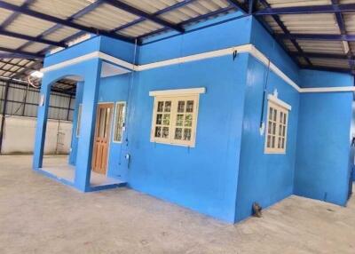 Blue building interior with exposed roof structure