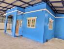 Blue building interior with exposed roof structure