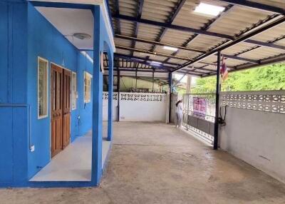 Covered outdoor area beside building with blue wall