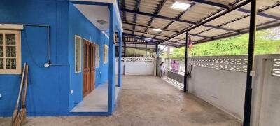 Covered outdoor area beside building with blue wall