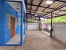 Covered outdoor area beside building with blue wall