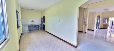 Spacious kitchen area with adjacent hallway