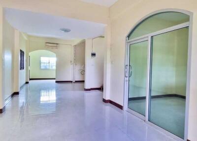 Spacious bright corridor with large windows and glass door