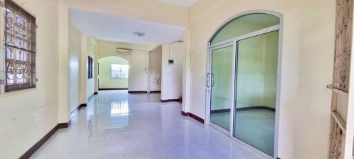 Spacious bright corridor with large windows and glass door