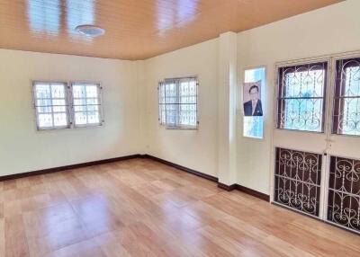 Spacious living room with wooden floor and large windows