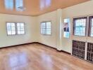 Spacious living room with wooden floor and large windows