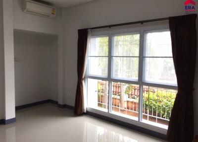 Well-lit empty living room with large windows