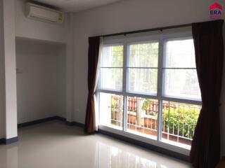 Well-lit empty living room with large windows