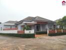 Front view of a modern single-story house with a landscaped yard