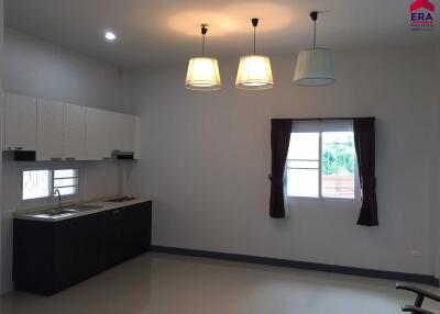 Modern kitchen with hanging lights, cabinets, and a sink