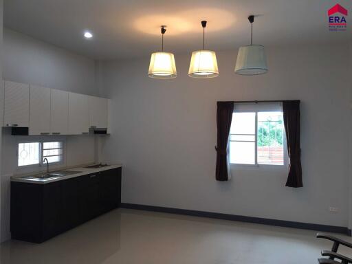 Modern kitchen with hanging lights, cabinets, and a sink