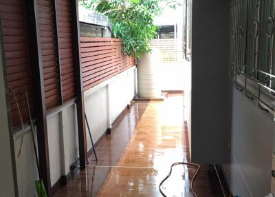 Covered patio area with wooden ceiling and tiled floor