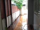 Covered patio area with wooden ceiling and tiled floor