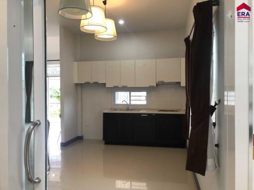 Modern kitchen with ample cabinetry and lighting