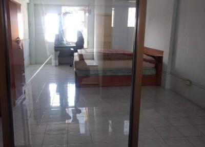 Spacious bedroom with glass doors and a desk by the window