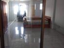 Spacious bedroom with glass doors and a desk by the window