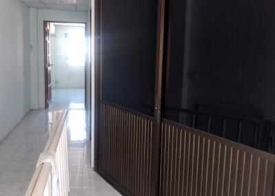 Corridor with dark glass doors and white railing