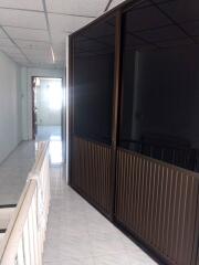 Corridor with dark glass doors and white railing